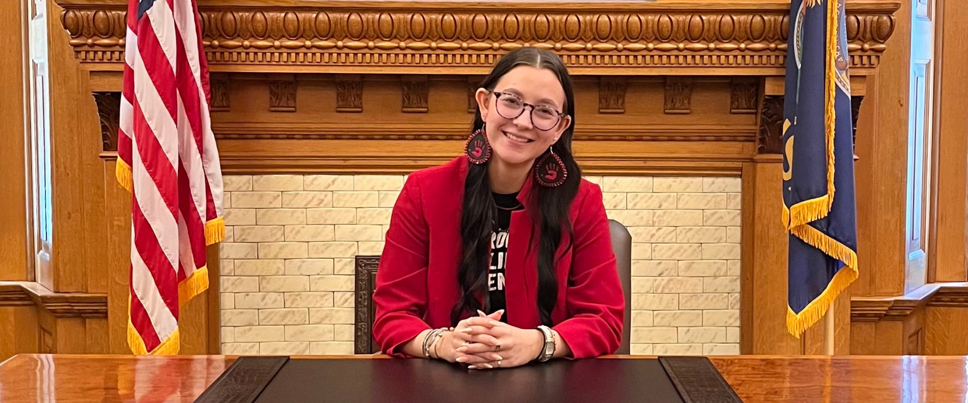 Arabella Gipp sits at the desk of Kansas Governor Laura Kelly during the Kansas Youth of the Year legislative day.